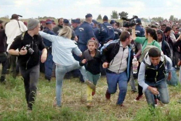 This video grab made on September 9, 2015 shows a Hungarian TV camerawoman later named as Petra Laszlo kicking a child as she run with other migrants from a police line during disturbances at Roszke, southern Hungary