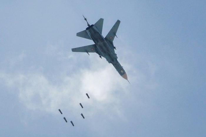 A Syrian warplane drops a payload on the rebel-held area of Qabun east of Damascus on May 6, 2017