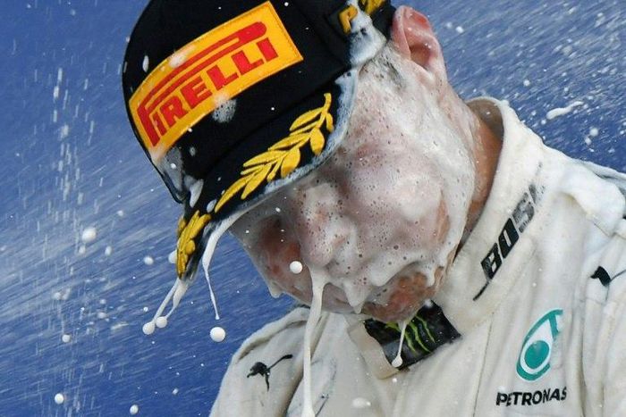 Mercedes' driver Valtteri Bottas celebrates on the podium after winning the Formula One Russian Grand Prix at the Sochi Autodrom on April 30, 2017
