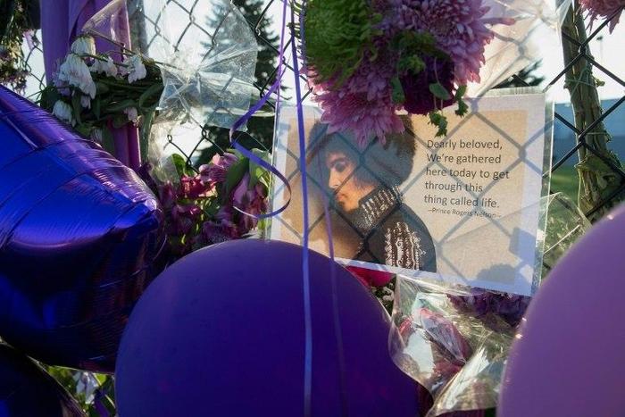 Mementos left by fans are attached to the fence surrounding Paisley Park, the home and studio of Prince, in this April 2016 file photo