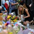 People lay flowers in tribute to the victims of the May 22 bomb attack in Manchester in northern England