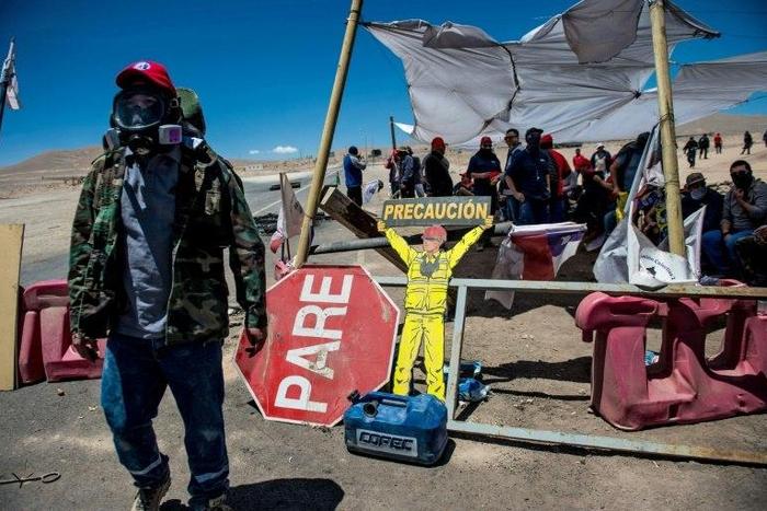 Workers of the Escondida copper mine block a road as they strike in Antofagasta, Chile, on February 15, 2017