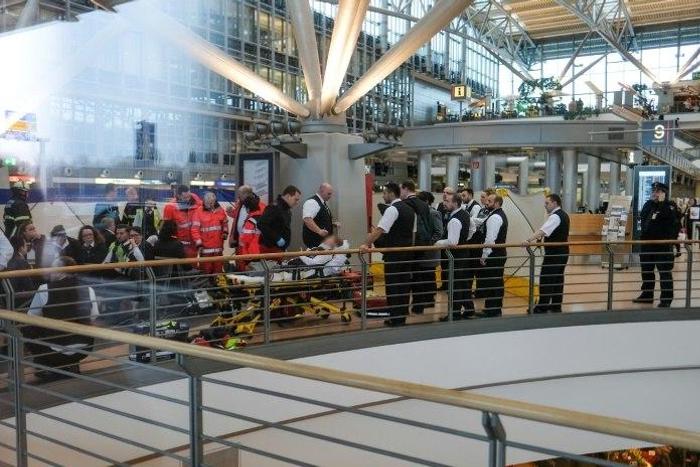 Firefighters take care of an individual on a stretcher inside Hamburg airport on February 12, 2017 in Hamburg, northern Germany, as emergency services evacuated the building after people reported respiratory ailments