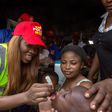 Tiwa Savage giving a child a polio vaccination