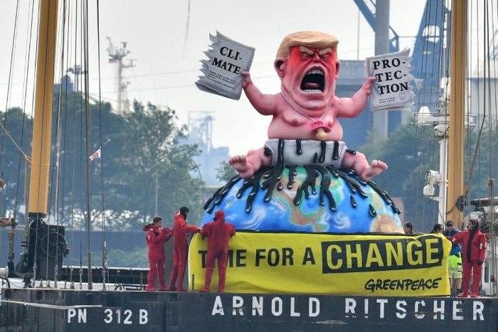 Greenpeace activists protest on a boat with a giant figure featuring US President Donald Trump in Hamburg, northern Germany where leaders of the world's top economies gather for a G20 summit