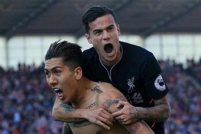 Liverpool's Brazilian midfielder Roberto Firmino (L) celebrates scoring his team's second goal with teammate Coutinho during their match against Stoke City in Stoke-on-Trent, central England on April 8, 2017