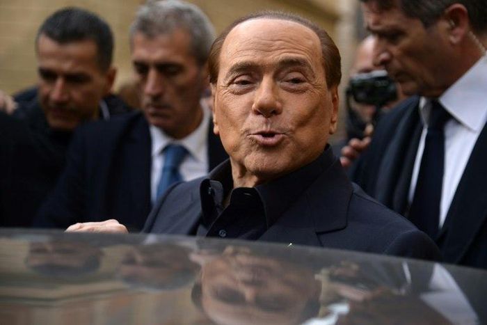 Former Italian prime minister Silvio Berlusconi leaves after voting in a referendum on constitutional reforms in Rome on December 4, 2016