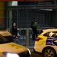 Police officers stand near a cordon at Manchester Victoria Station following a stabbing