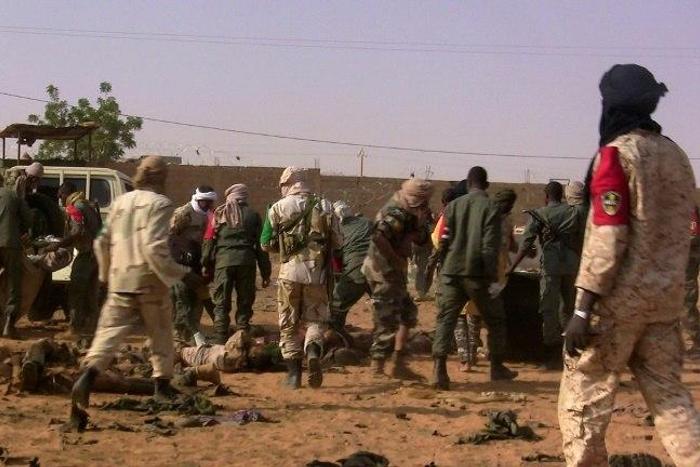 The dead and injured are evacuated following a suicide bomb attack that ripped through a camp grouping former rebels and pro-government militia in Gao, in northern Mali