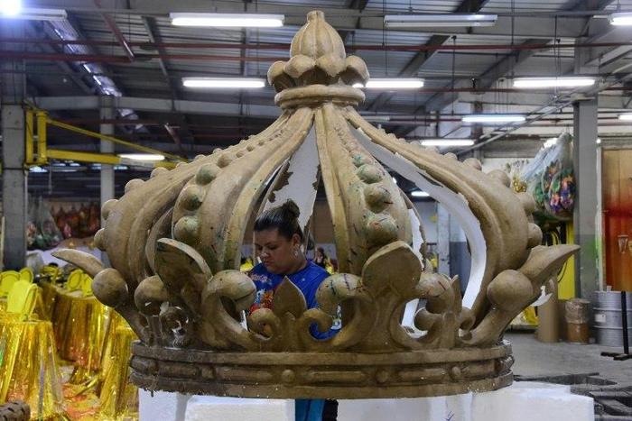 A woman works on the floats of the Sao Clemente samba school in Rio de Janeiro which this year features a lavish portrayal of France under the Sun King, Louis XIV