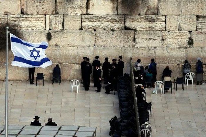 Ultra-Orthodox Jewish men (L) and women (R) pray in different sections of the Western Wall in Jerusalem's Old City on February 2, 2016