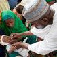 Nigerian health official administers a polio vaccine to a child in Kano, northern Nigeria