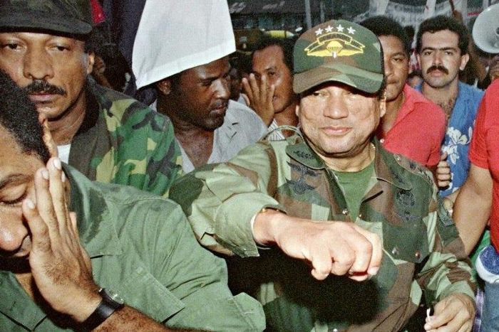 Panamanian dictator Manuel Noriega playfully fakes a punch to a supporter at the height of his power in 1989