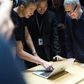 Apple plans to borrow for its new "advanced manufacturing" fund despite having money overseas, because of the tax it would pay if it brought profit home, said CEO Tim Cook (R)