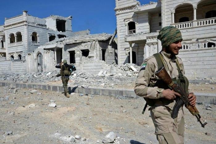 Rebel fighters, seen here, are working with Turkish troops to flush out IS jihadists from Al-Bab