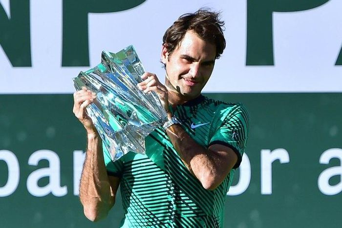 Roger Federer of Switzerland lifts the trophy following his victory over compatriot Stan Wawrinka in the ATP Indian Wells Masters final match, in California, on March 19, 2017