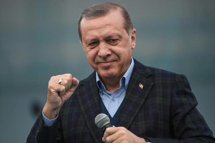 Turkish President Recep Tayyip Erdogan gestures as he delivers a speech on April 8, 2017 during a campaign rally for the "yes" vote in a constitutional referendum in Istanbul