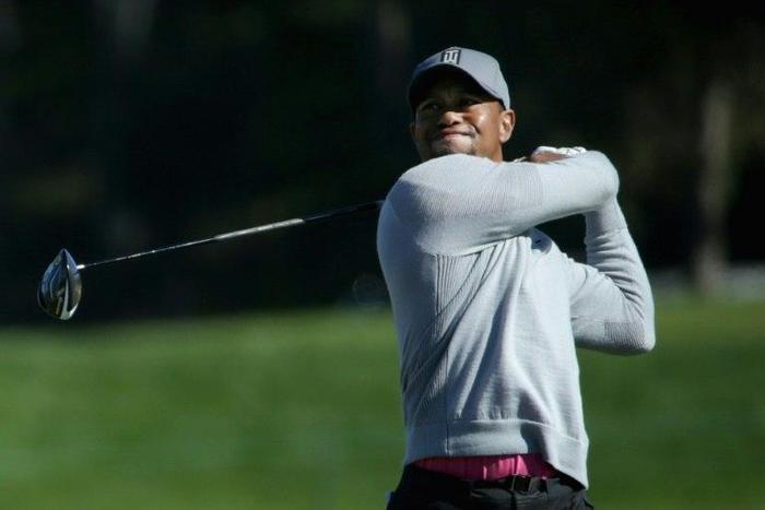 This photo taken on January 26, 2017 shows Tiger Woods as he plays his shot from the 14th tee during the second round of the Farmers Insurance Open at Torrey Pines North in San Diego, California