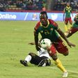 Cameroon's midfielder Christian Bassogog (C) advances past Ghana's midfielder Frank Acheampong to score his team's second goal during 2017 Africa Cup of Nations semi-final football match between Cameroon and Ghana in Franceville on February 2, 2017