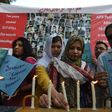 Residents of Karachi hold lighted candles during a ceremony on December 16, 2016, as they pay tribute to victims on the second anniversary of an attack on The Army Public School in the northwestern city of Peshawar Parents of children killed when Talib...