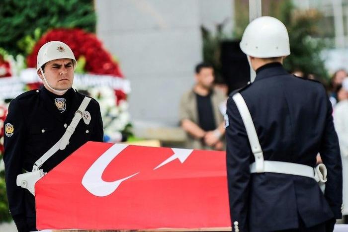 Turkish police stand next to the coffin of slain colleague Sinan Acar during his funeral ceremony in Istanbul on August 14, 2017