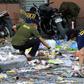 Scattered debris including items traditionally sold for New Year celebrations, such as cardboard and plastic horns and gifts, as well as a bloody slipper, lay at the mall's entrance where the explosion took place