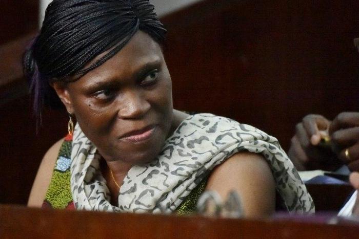 Former Ivorian first lady Simone Gbagbo looks on at Abidjan's courthouse on October 10, 2016 before the re-opening of her trial