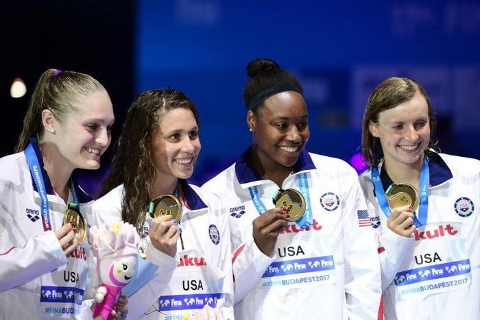 USA's Katie Ledecky, Mallory Commerford, Kelsi Forrel and Simone Manuel celebrate on the podium after winning the women's 4x100m freestyle relay in Budapest, on July 23, 2017