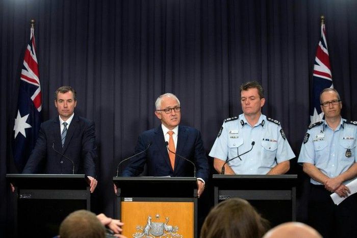Prime Minister Malcolm Turnbull (2nd L)says the arrest of a man charged with helping the Islamic State group is a reminder that terrorism is an enduring threat