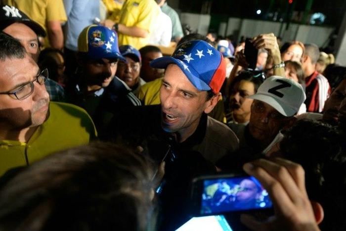 Venezuelan opposition leader Henrique Capriles (C) told the media in Caracas "If the dictatorship is squealing, it is a sign that we are making progress"