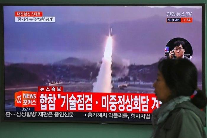 A TV screen shows file footage of a North Korean missile launch, with China's top nuclear envoy now in Seoul for talks on the North Korean threat