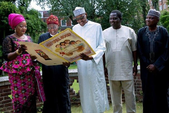 Buhari (centre) receives a giant Get Well card, in this handout photo taken on August 12 in London, where the Nigerian president has been receiving treatment for an undisclosed ailment for over three months