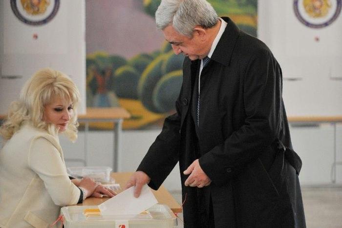 Armenian President Serzh Sarkisian casts his ballot in elections observers say were marred by allegations of fraud
