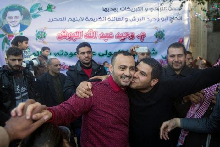 UN worker Waheed Borsh (centre) celebrates with his Palestinian relatives after he was released from an Israeli prison on January 12, 2017