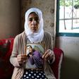 Manal al-Saayed, the mother of Israeli citizen Hisham al-Sayed, holds a picture of her son who is believed to have been held by Hamas since April 2015