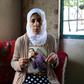 Manal al-Saayed, the mother of Israeli citizen Hisham al-Sayed, holds a picture of her son who is believed to have been held by Hamas since April 2015