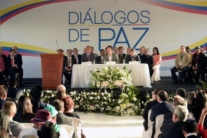 Colombian government representative Juan Camilo Restrepo (C-L), Ecuadorean Foreign Minister Guillaume Long (C) and Colombia's ELN guerrilla member Pablo Beltran (C-R) attend peace talks in Sangolqui, Ecuador on February 7, 2017