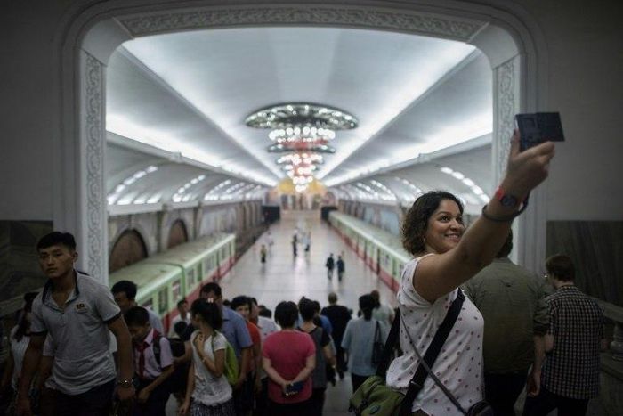A tourist takes a selfie during a visit to a subway station in Pyongyang -- around 5,000 Western travellers visit the North each year, tour companies say