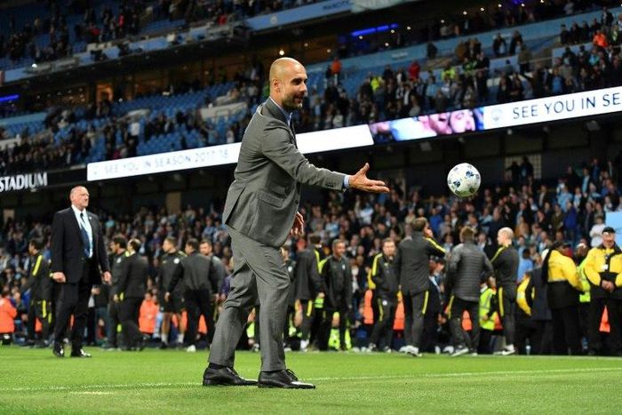 Manchester City's manager Pep Guardiola plays with a small ball on the pitch at the end of the English Premier League football match against West Bromwich Albion May 16, 2017