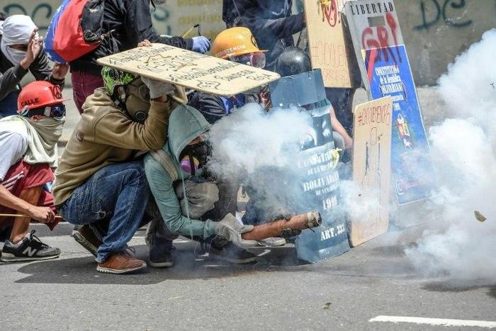 Opposition demonstrators clash with police during a protest in Caracas