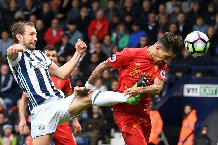 Liverpool's Roberto Firmino heads the opening goal past West Bromwich Albion's Craig Dawson during the English Premier League match at The Hawthorns in West Bromwich, central England, on April 16, 2017