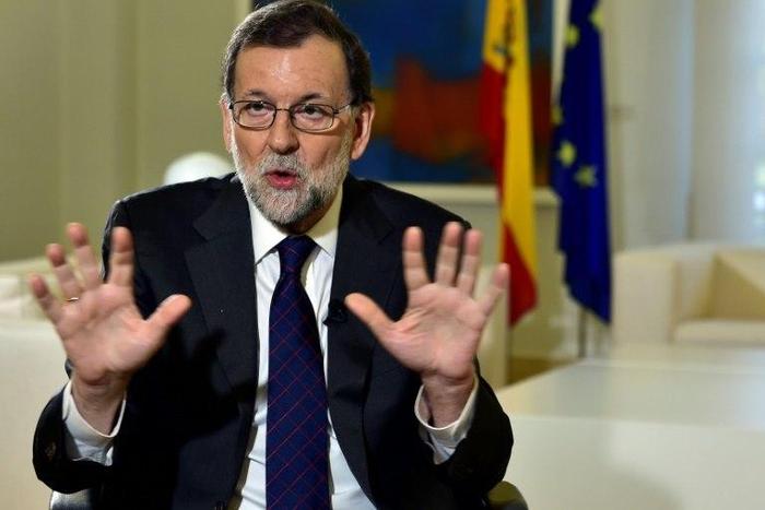 Spanish Prime Minister Mariano Rajoy gestures during an AFP interview at La Moncloa Palace in Madrid