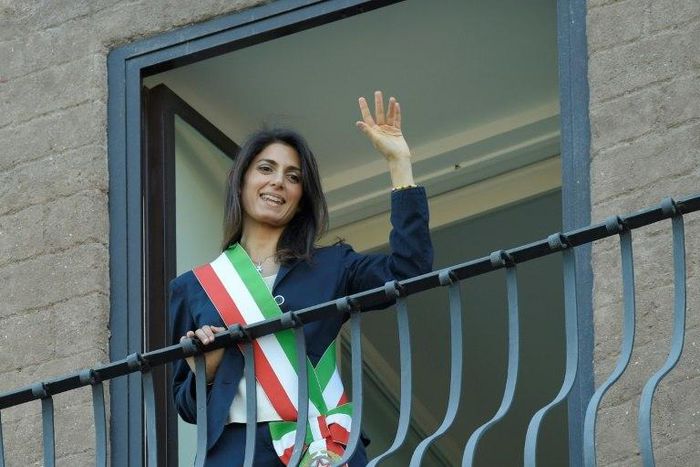 Newly elected mayor of Rome, Virginia Raggi, waves to people from the balcony of Rome's city hall on June 23, 2016, after her official investiture