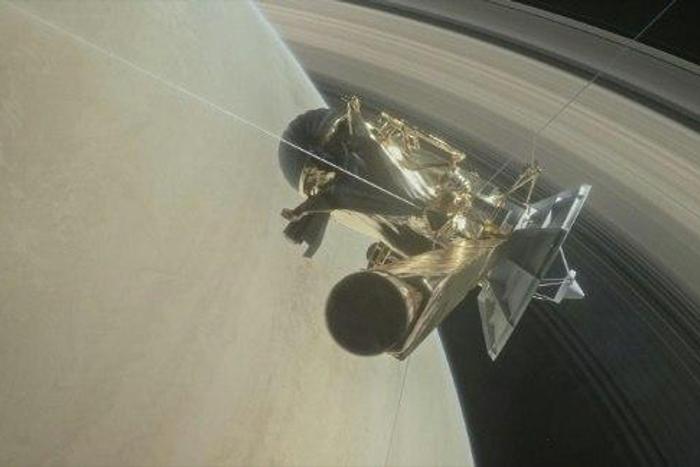 This NASA handout image depicts the Cassini unmanned spacecraft above Saturn's rings