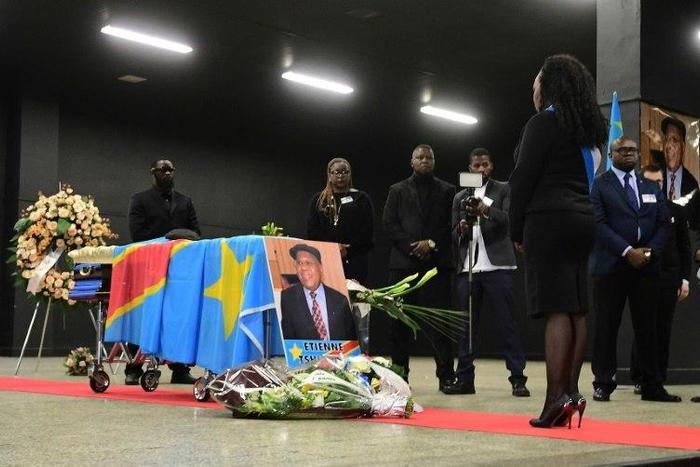 A woman stands in front of the coffin of Democratic Republic of Congo's opposition leader Etienne Tshisekedi during a funeral wake in his honour, in Brussels on February 5, 2017