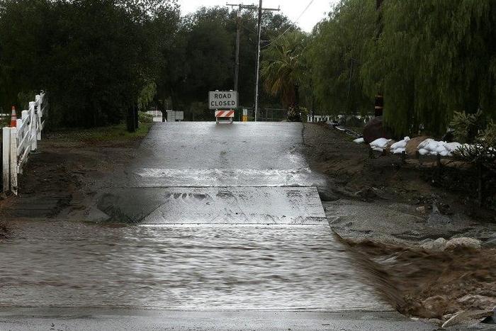 A road is blocked off due to floodwaters on January 23, 2017 in Santa Clarita, California
