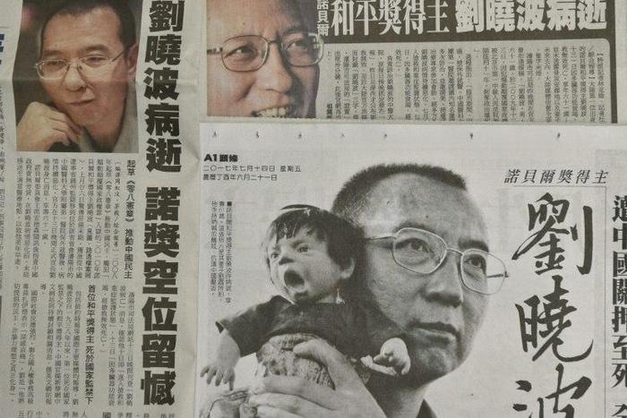 This photo illustration shows a collection of Taiwanese newspapers in Taipei on July 14, 2017 reporting on the death of China's Nobel laureate Liu Xiaobo