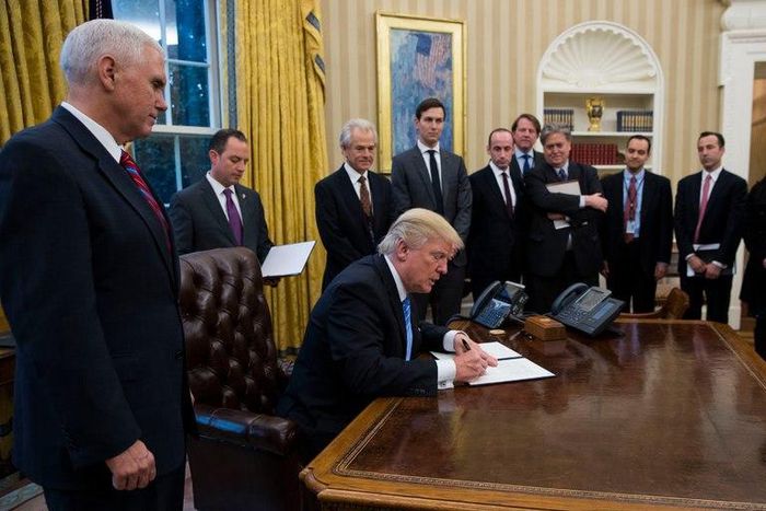 President Trump signing memoranda in the Oval Office on Monday.