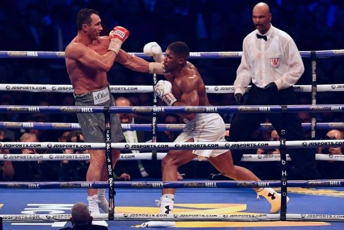 Ukraine's Wladimir Klitschko (L) defends against Britain's Anthony Joshua during the tenth round of their IBF, IBO and WBA, world Heavyweight title fight at Wembley Stadium in north west London on April 29, 2017
