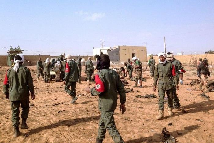 Soldiers attend to wounded and casualties following a suicide bomb attack in Gao, northern Mali on January 18, 2017